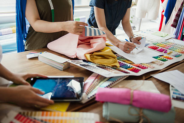 three female workers meeting in fashion design studio.